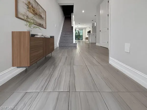 a living room with furniture a rug and a painting