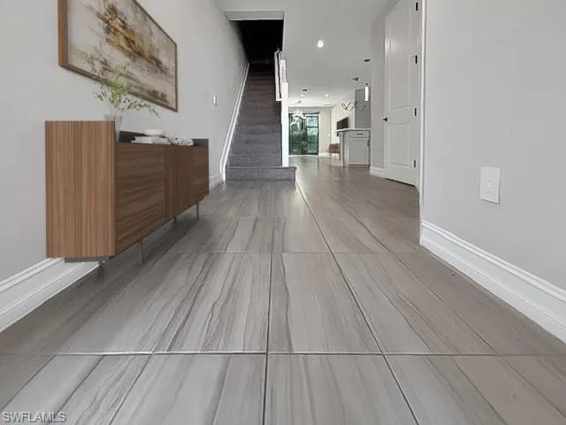 a living room with furniture a rug and a painting