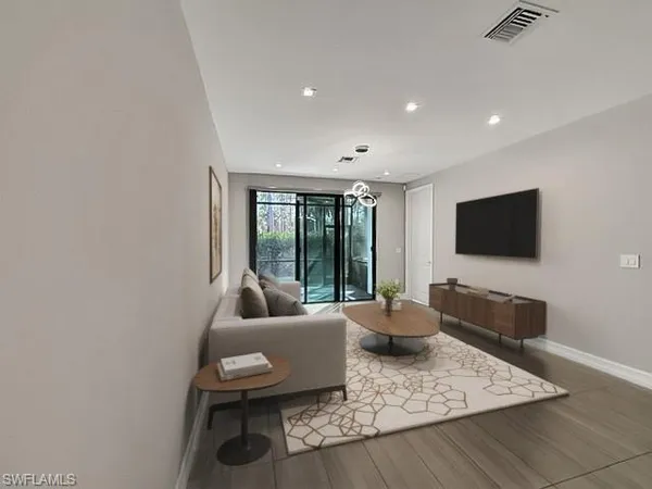 a living room with furniture and chandelier