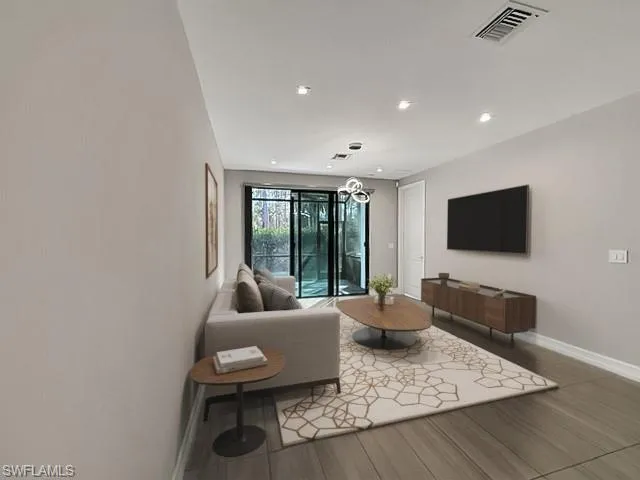 a living room with furniture and chandelier