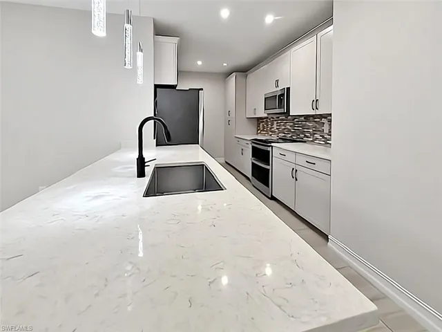 a kitchen with cabinets and stainless steel appliances