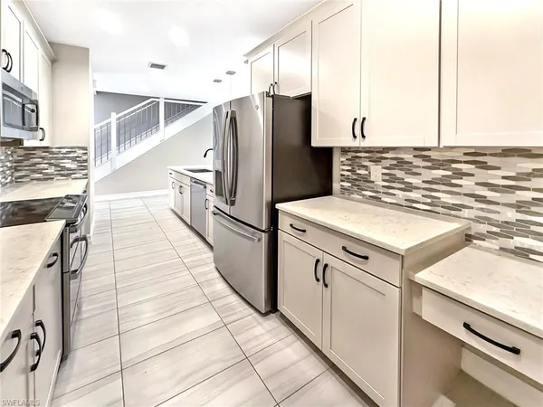 a spacious bedroom with a bed and a flat screen television