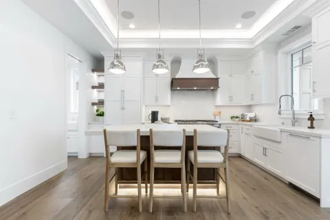 a dining room with furniture potted plants and wooden floor