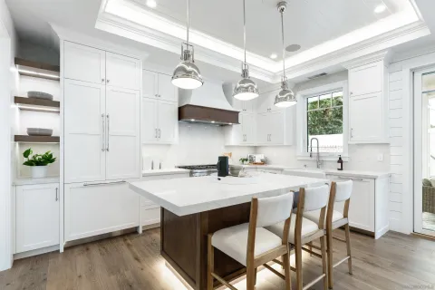 a kitchen with stainless steel appliances a sink a stove a table and chairs