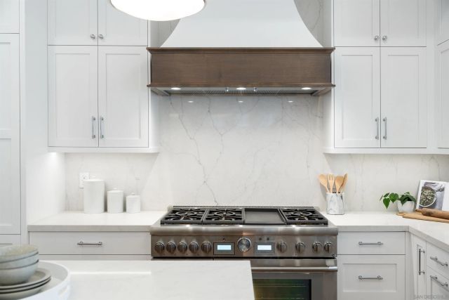 a kitchen with granite countertop cabinets stainless steel appliances and a sink