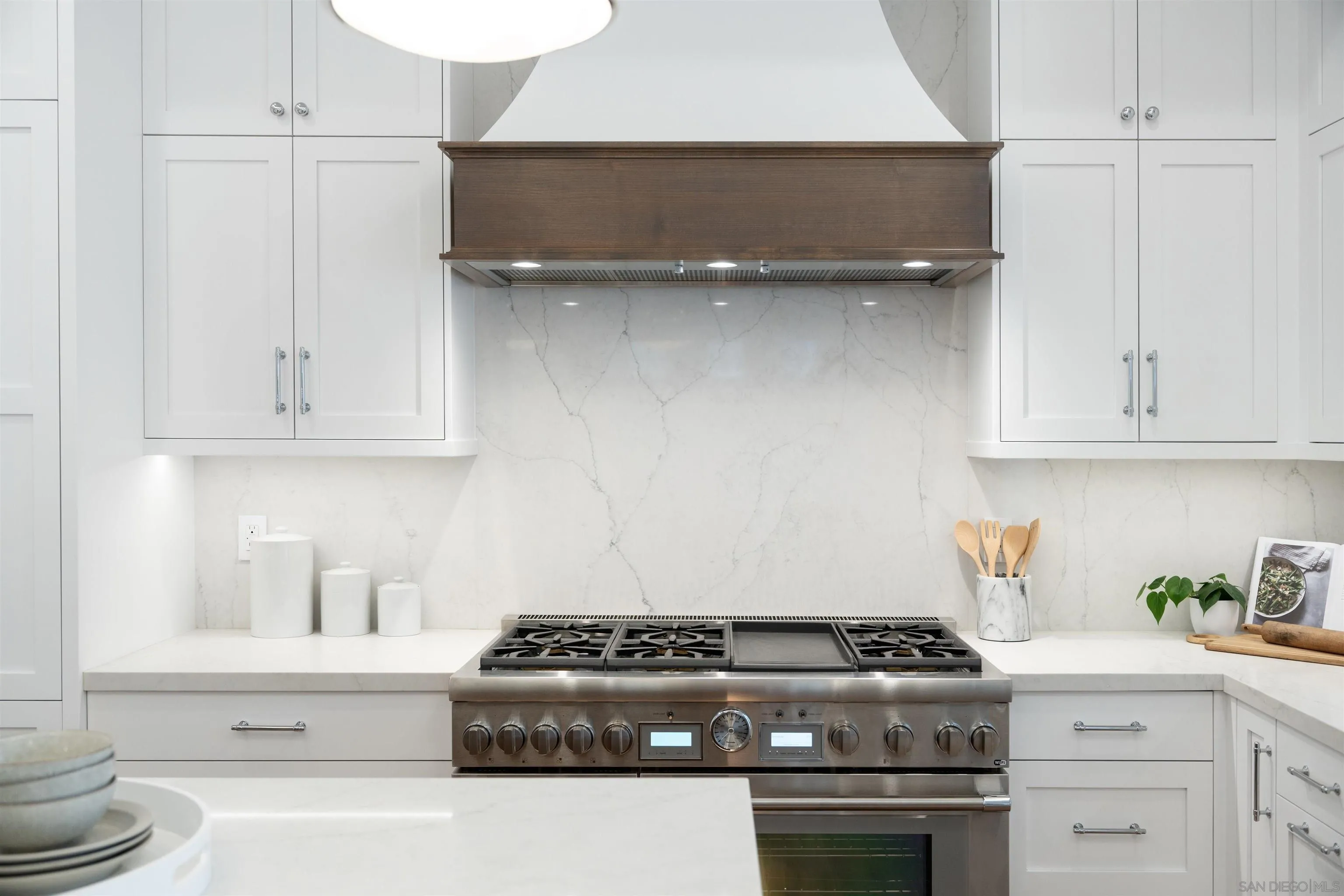 462 Westbourne Street La Jolla, CA 92037 - Photo 17 of 75 a white stove top oven sitting inside of a kitchen