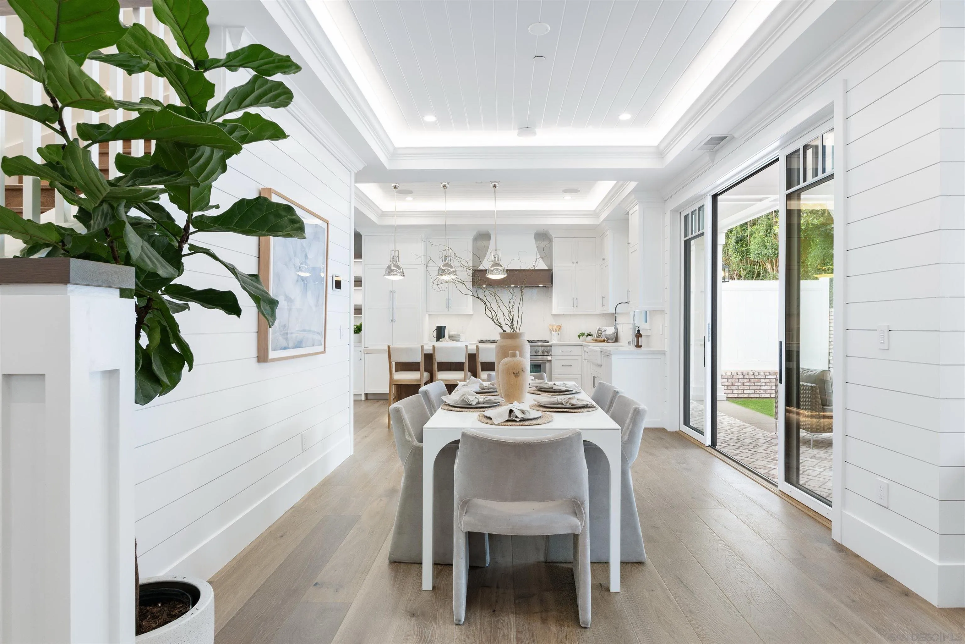 462 Westbourne Street La Jolla, CA 92037 - Photo 18 of 75 a dining room with furniture potted plants and wooden floor
