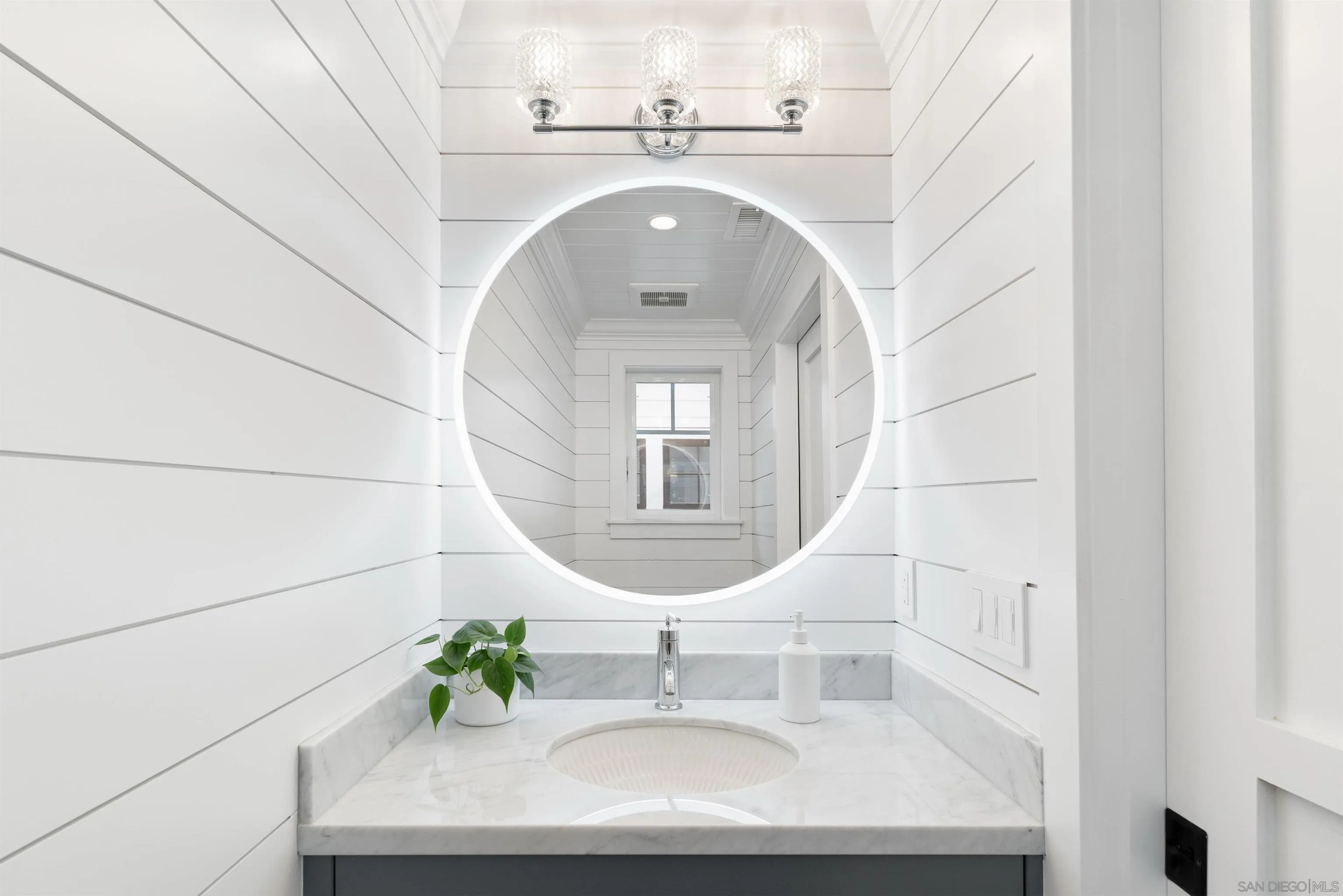 462 Westbourne Street La Jolla, CA 92037 - Photo 35 of 75 a bathroom with a sink and a mirror