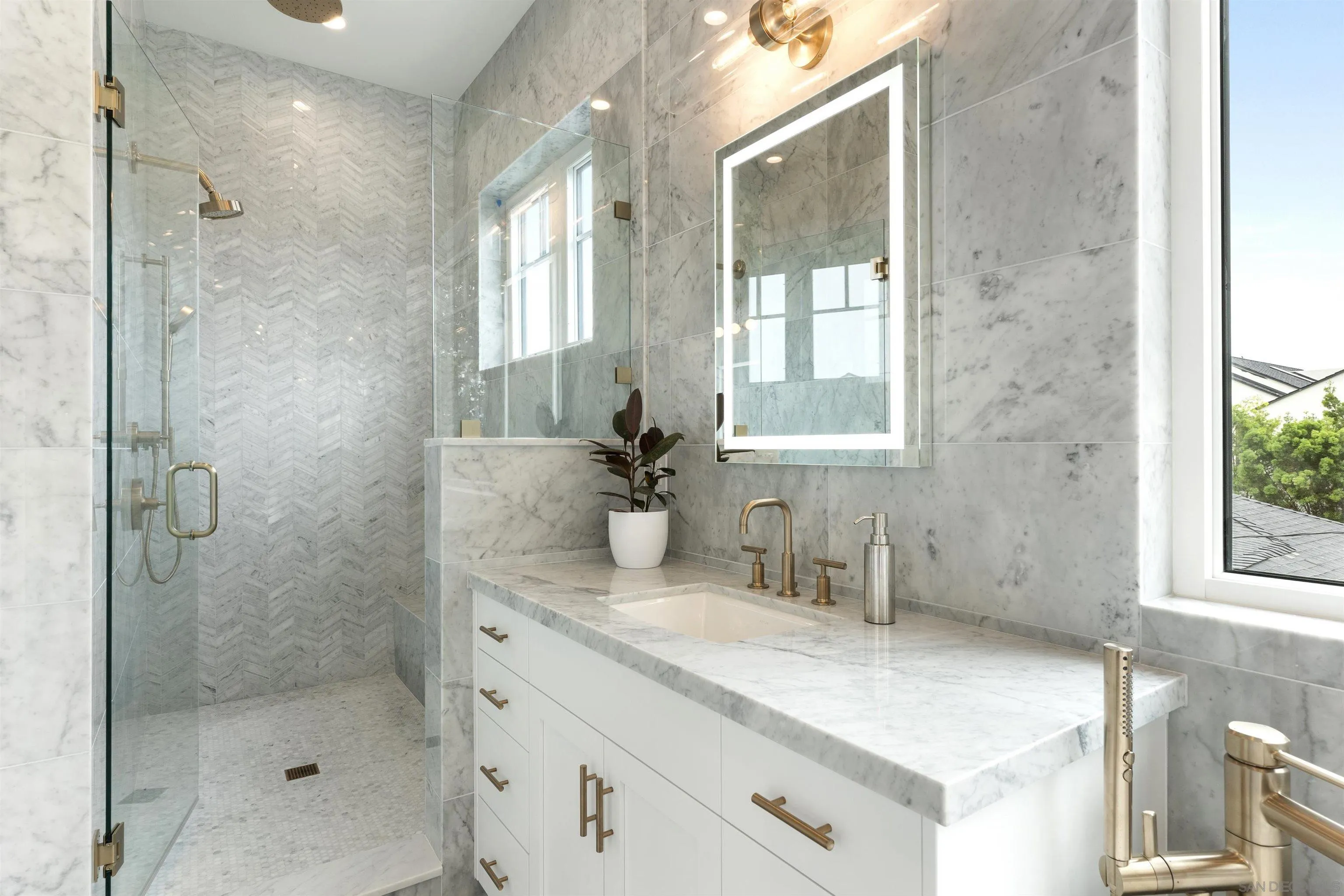 462 Westbourne Street La Jolla, CA 92037 - Photo 44 of 75 a bathroom with a shower sink and mirror