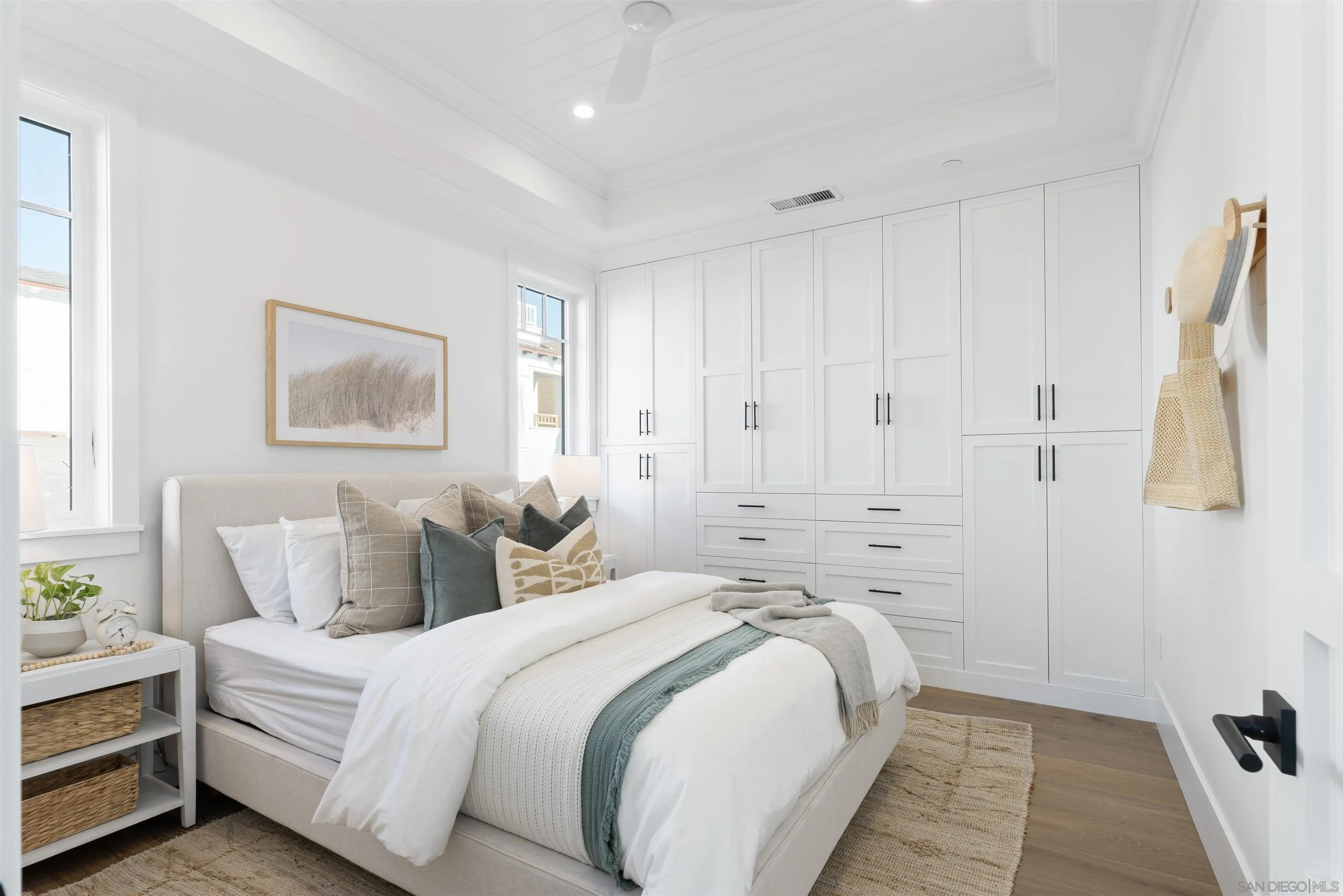 462 Westbourne Street La Jolla, CA 92037 - Photo 55 of 75 a spacious bedroom with a bed and painting on the wall