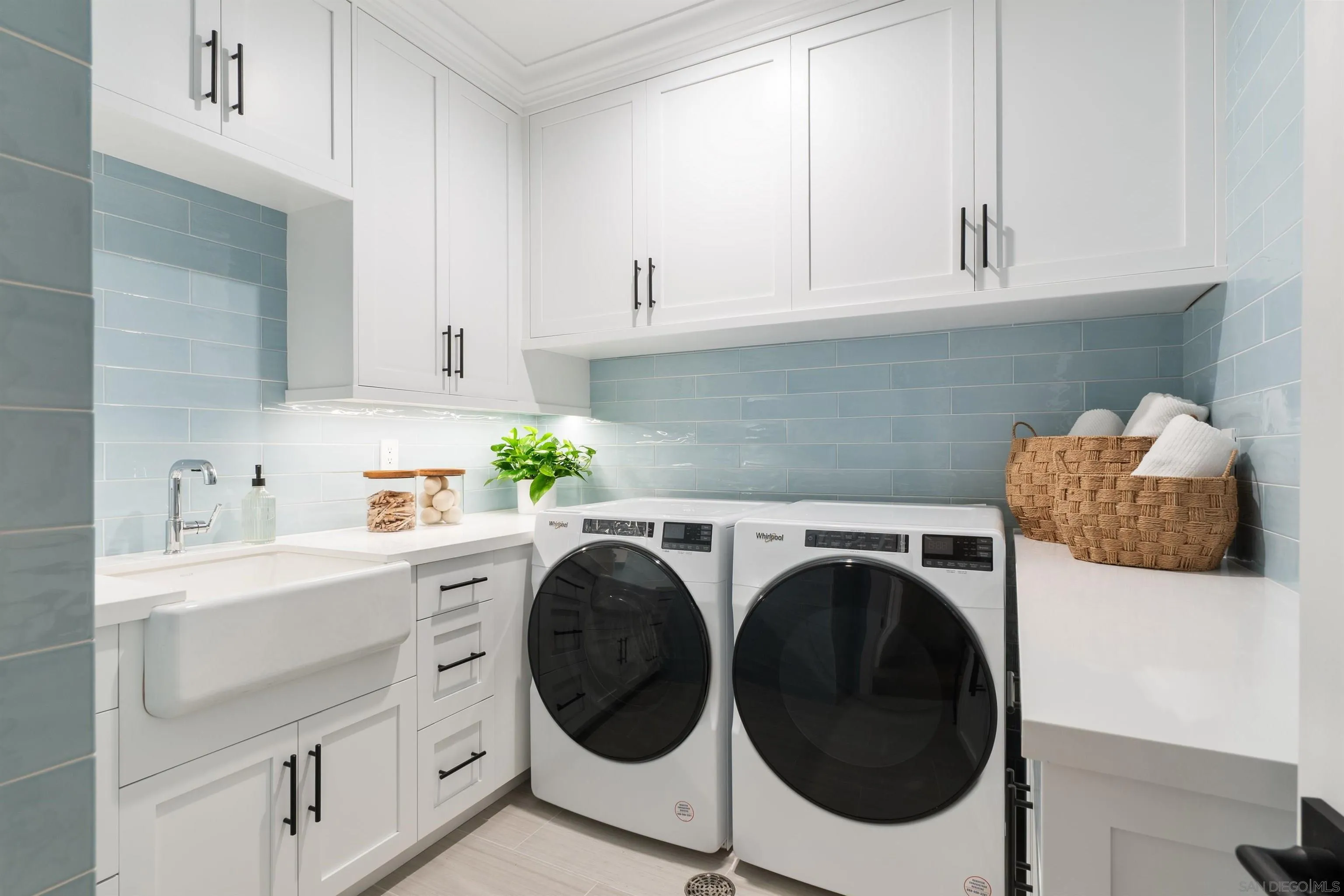 462 Westbourne Street La Jolla, CA 92037 - Photo 56 of 75 a utility room with sink dryer and washer