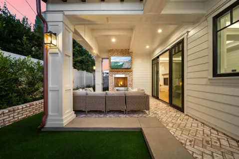 a view of a patio with couches table and chairs and potted plants