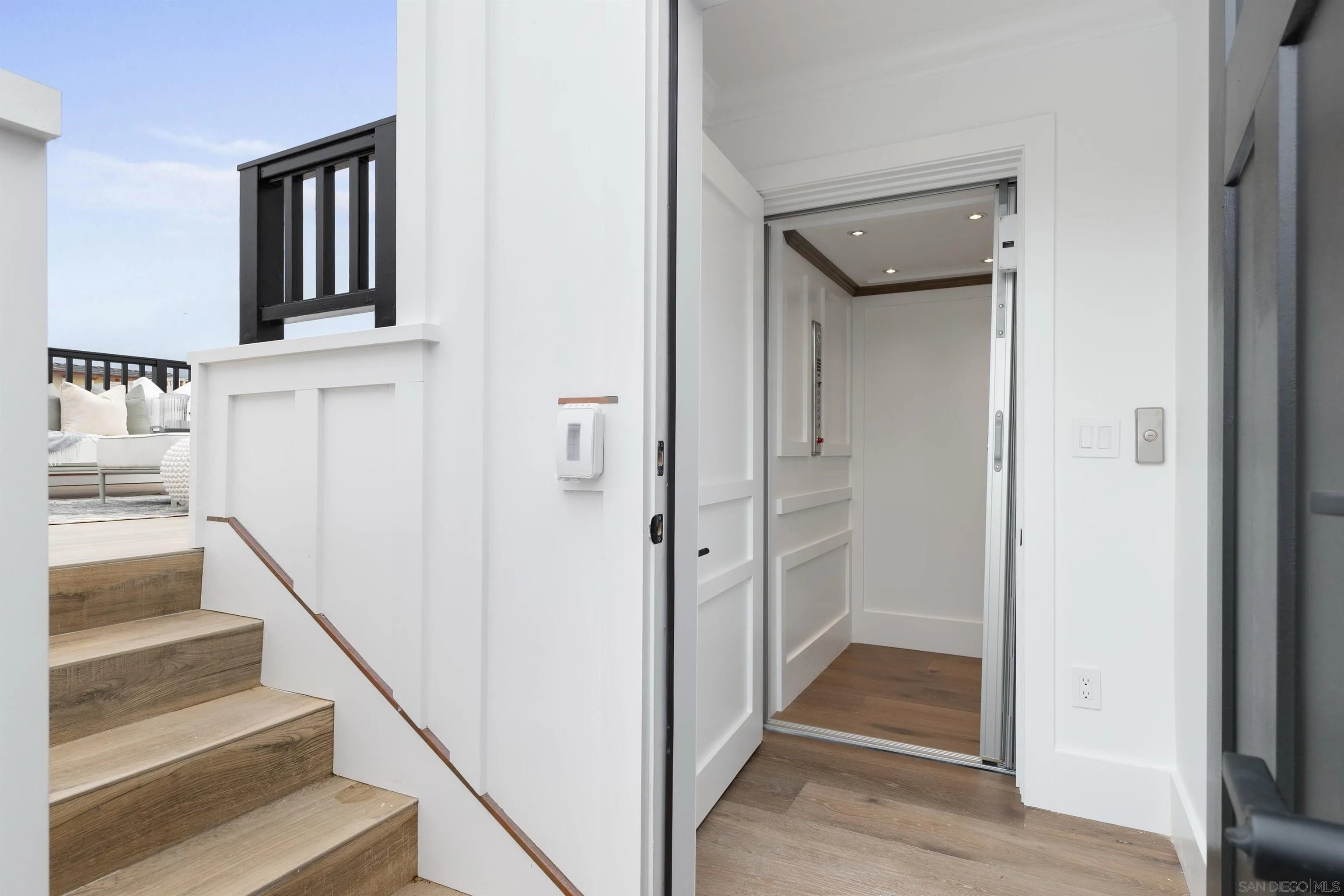 462 Westbourne Street La Jolla, CA 92037 - Photo 66 of 75 a view of a hallway with wooden floor and staircase