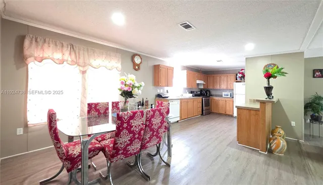 a view of a dining room with furniture and a large window