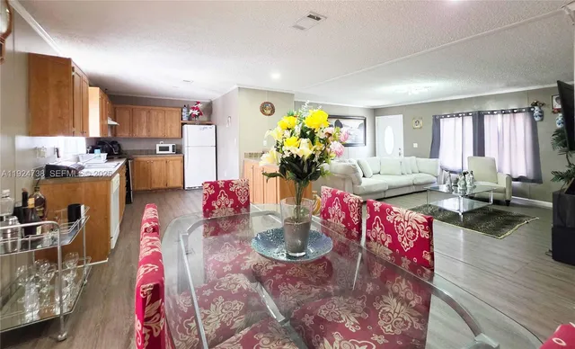 a very nice looking living room with kitchen island furniture and a wooden floor