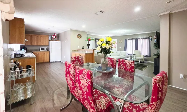 a view of a dining room with furniture and a chandelier