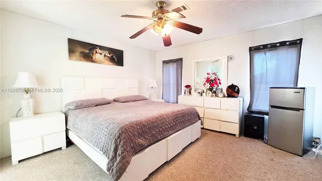 a bedroom with a bed chandelier and dresser