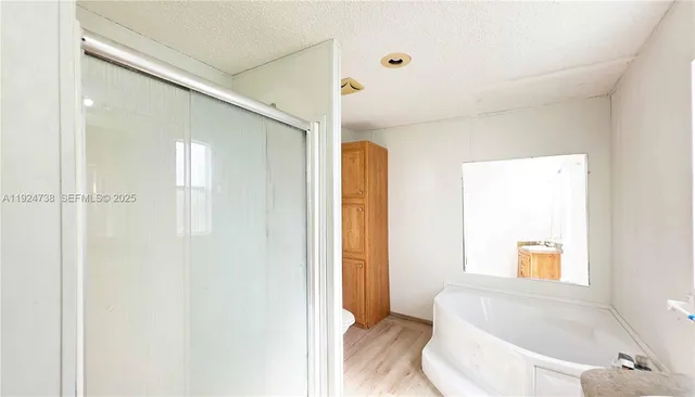 a bathroom with a bathtub and shower