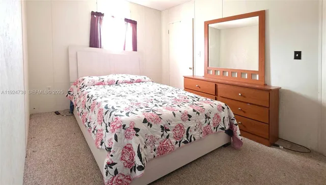 a bedroom with a bed and a mirror
