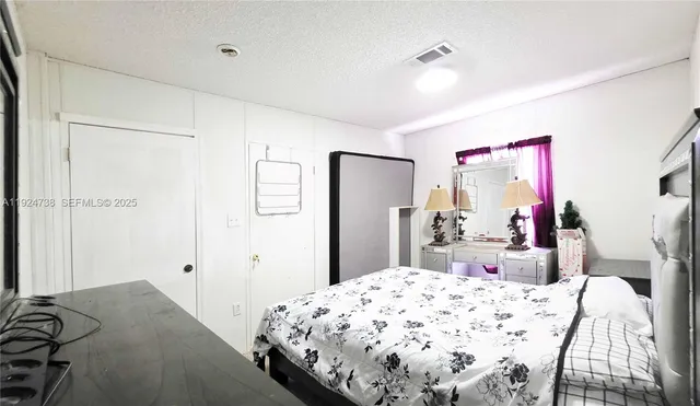 a bedroom with a bed and a dresser