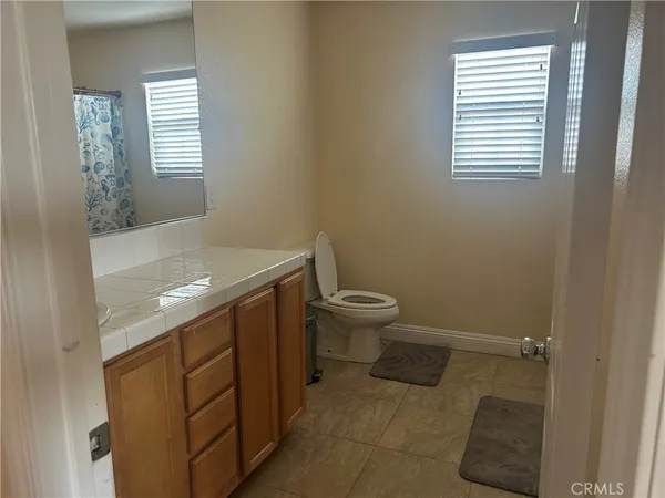 a bathroom with a sink toilet and window