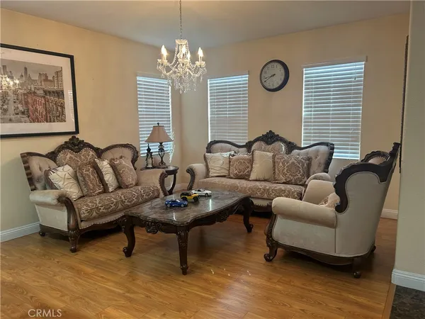 a living room with furniture and a chandelier