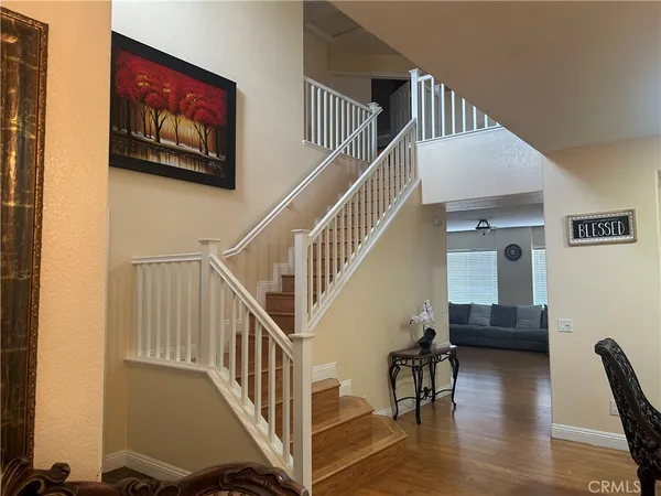 a view of entryway and hall with wooden floor