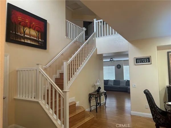a view of entryway livingroom and hall with wooden floor