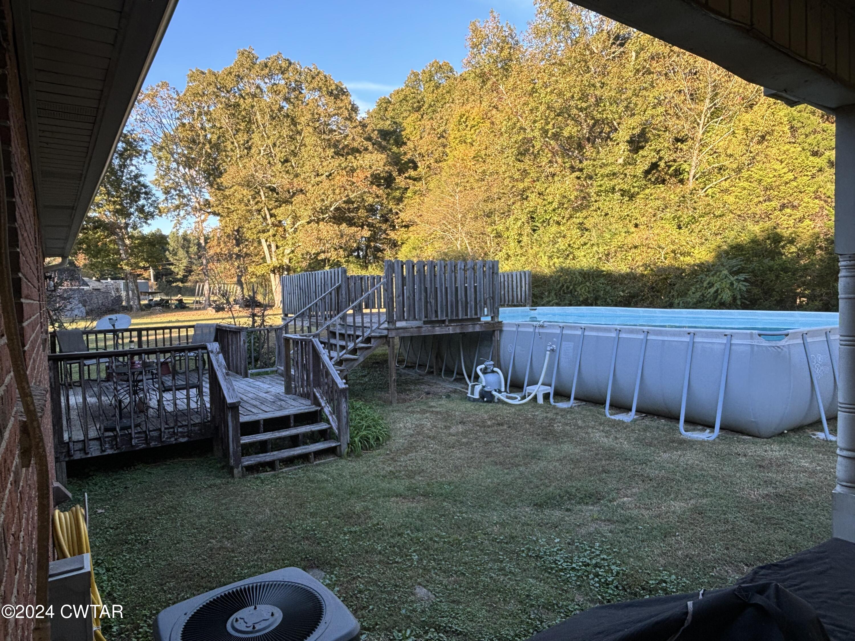 3100 Black Bottom Road Lexington, TN 38351 - Photo 16 of 16 a view of a backyard with wooden fence and a chairs