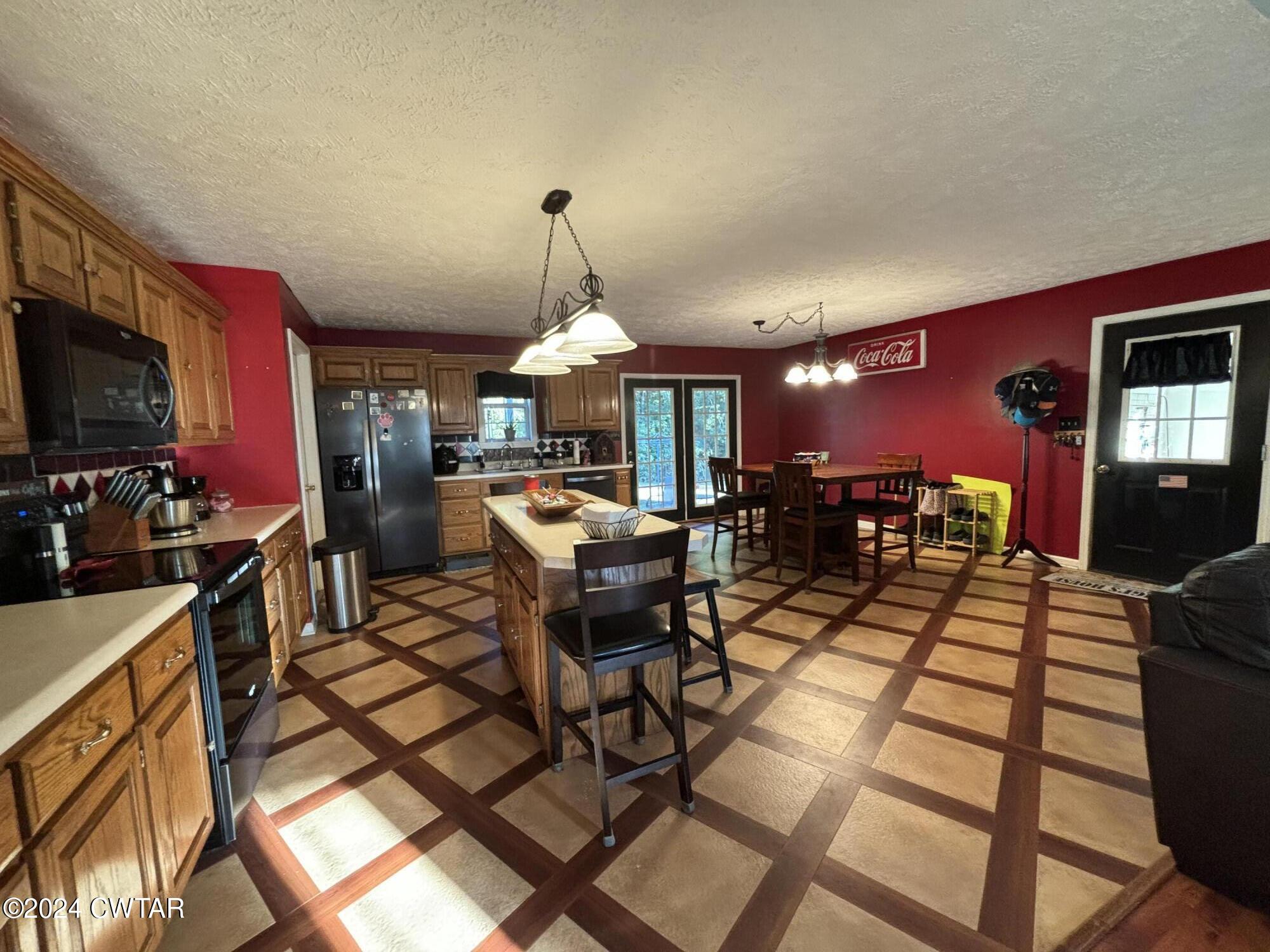 3100 Black Bottom Road Lexington, TN 38351 - Photo 6 of 16 a view of a dining room with furniture a kitchen and chandelier