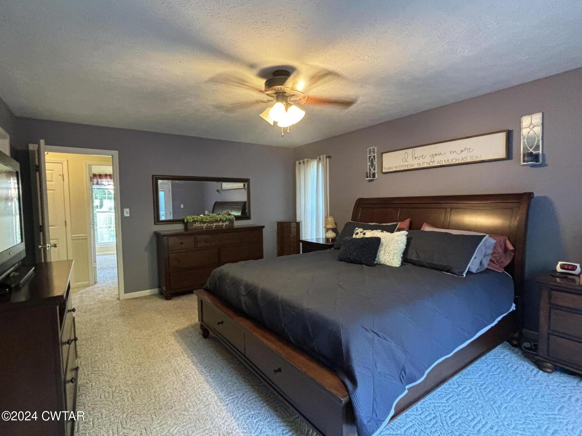 3100 Black Bottom Road Lexington, TN 38351 - Photo 7 of 16 a bedroom with a bed and a flat tv screen on dresser