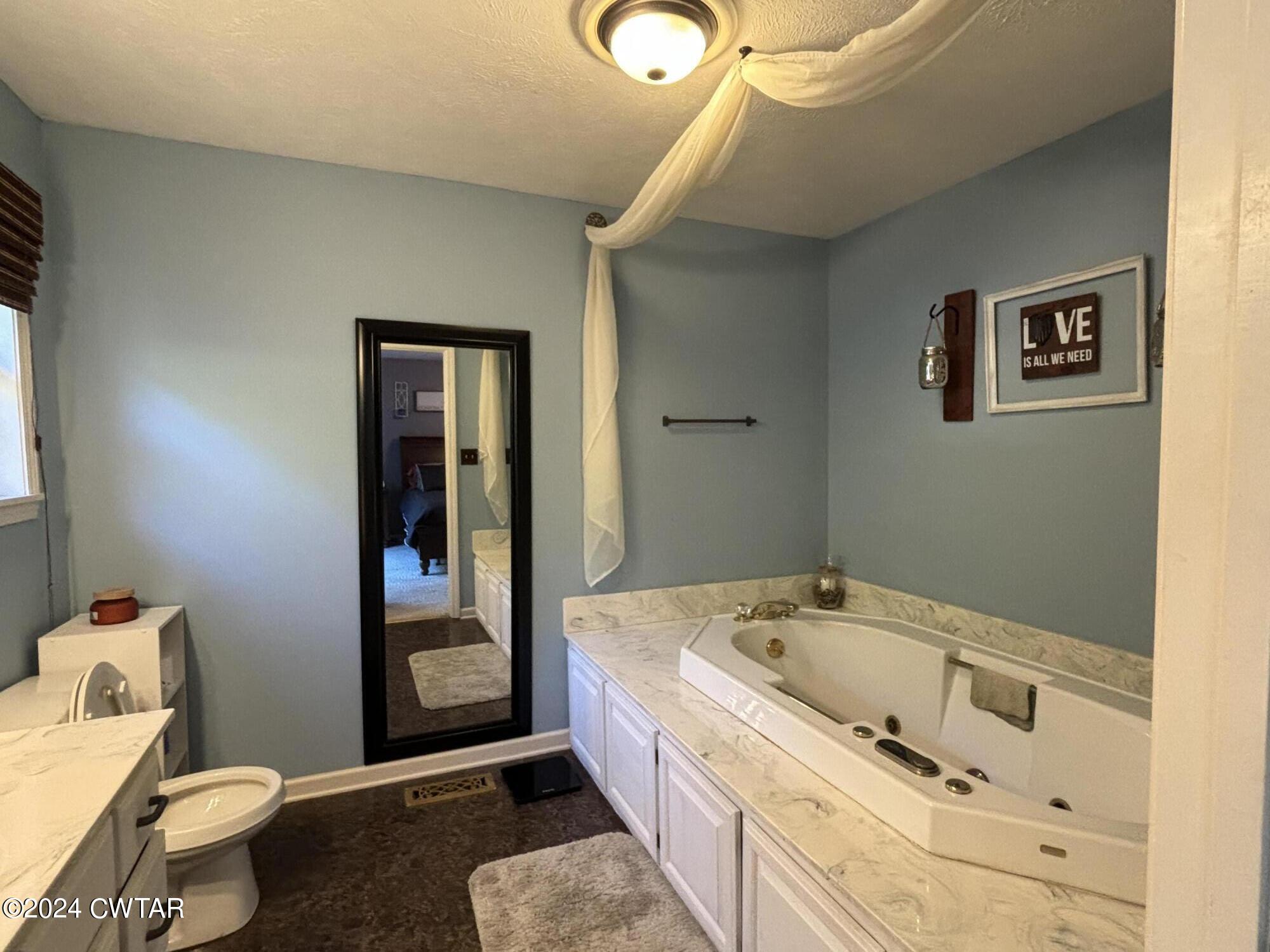 3100 Black Bottom Road Lexington, TN 38351 - Photo 8 of 16 a bathroom with a tub and toilet