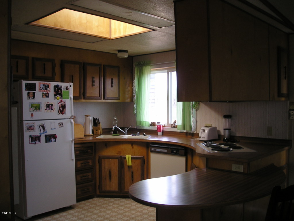 2681 Rosenkranz Road Tieton, WA 98947 - Photo 7 of 11 a kitchen with kitchen island granite countertop a sink a stove and refrigerator