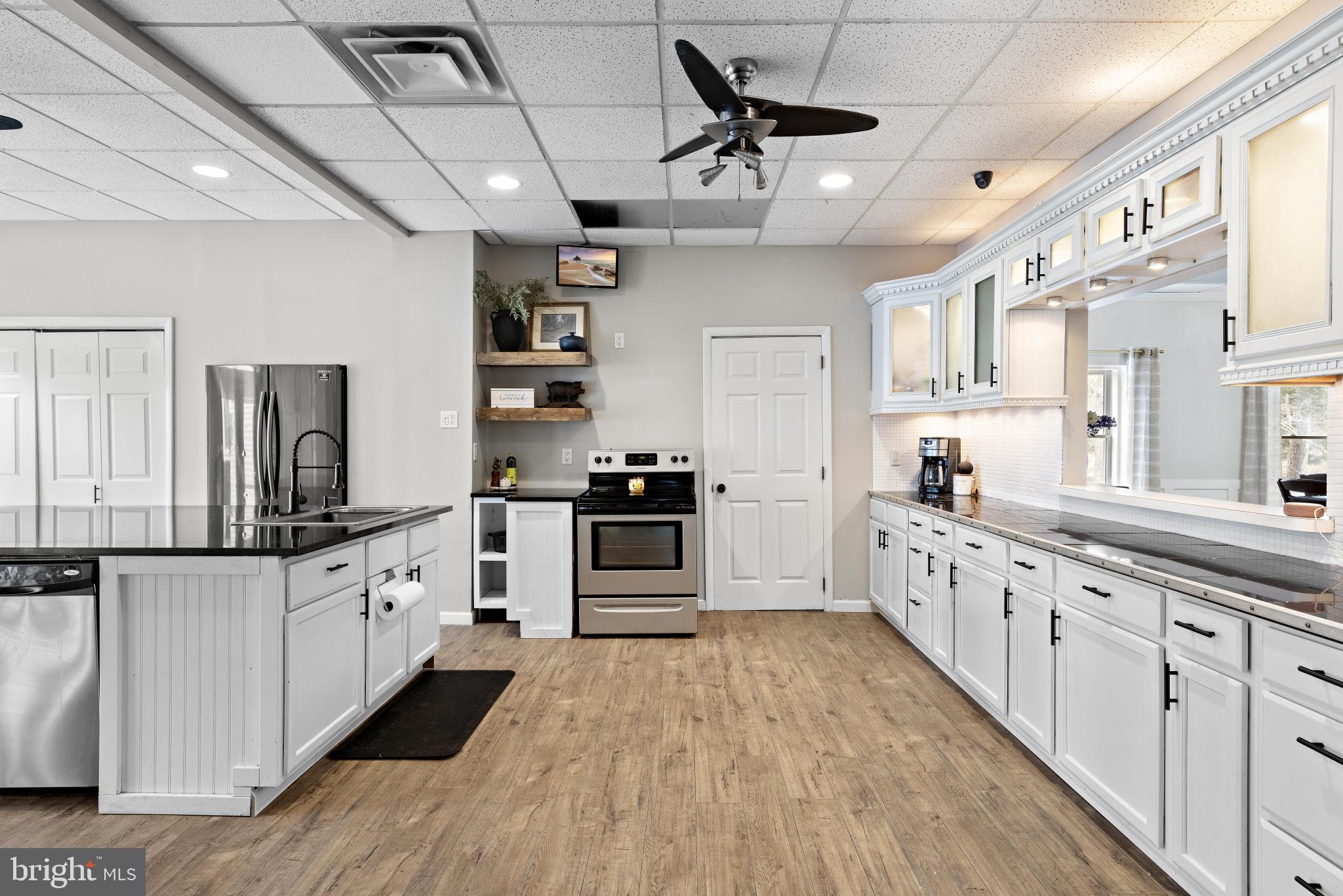 77 West Greenbush Road Tuckerton, NJ 08087 - Photo 17 of 75 a kitchen with granite countertop a large counter top space a sink stainless steel appliances and cabinets