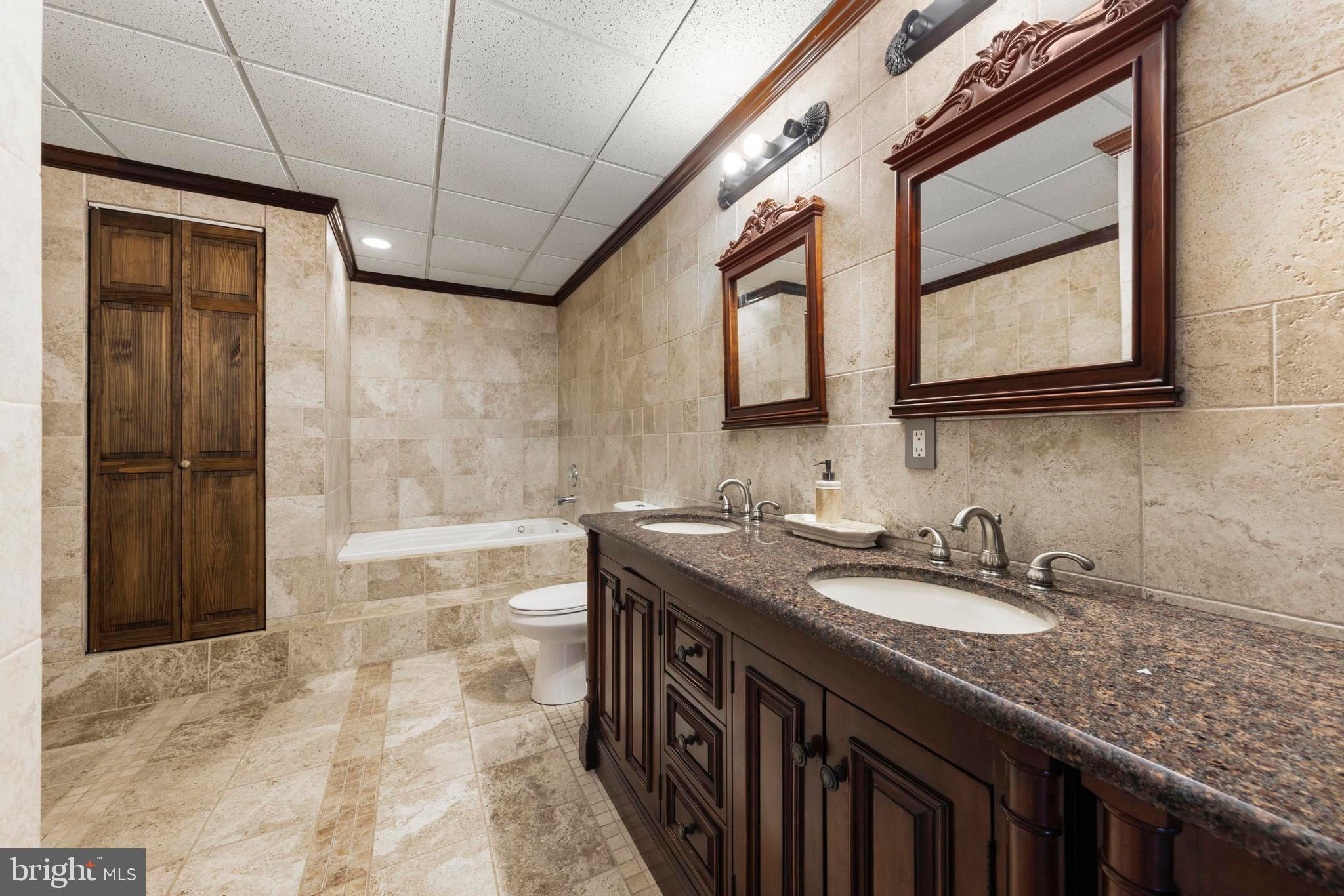 77 West Greenbush Road Tuckerton, NJ 08087 - Photo 29 of 75 a bathroom with a granite countertop sink a vanity and a shower