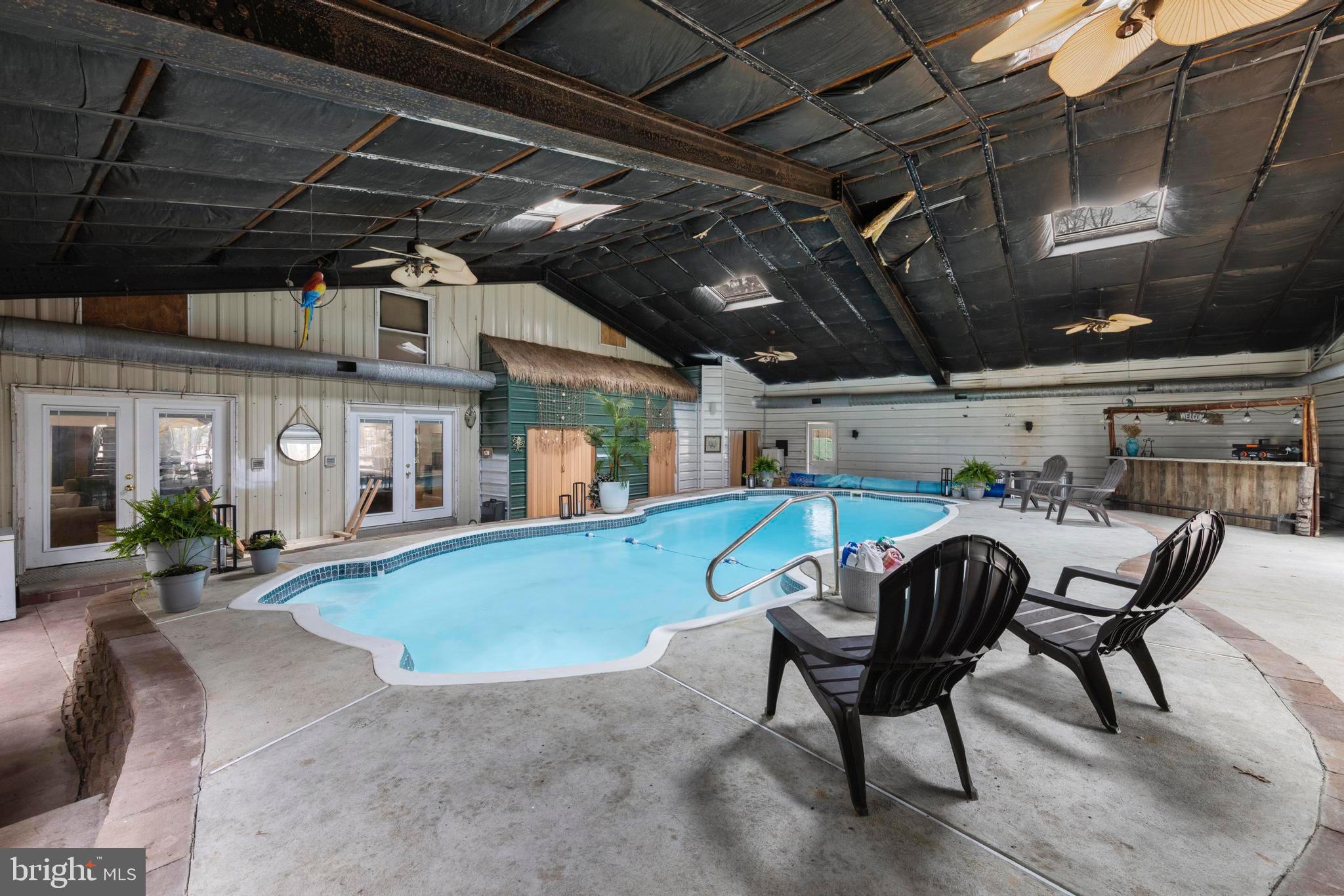 77 West Greenbush Road Tuckerton, NJ 08087 - Photo 55 of 75 a view of a swimming pool with a table and chairs in patio