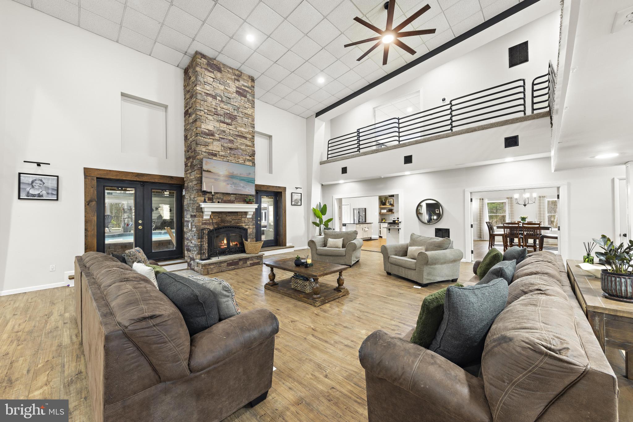 77 West Greenbush Road Tuckerton, NJ 08087 - Photo 7 of 75 a living room with furniture a fireplace and a chandelier