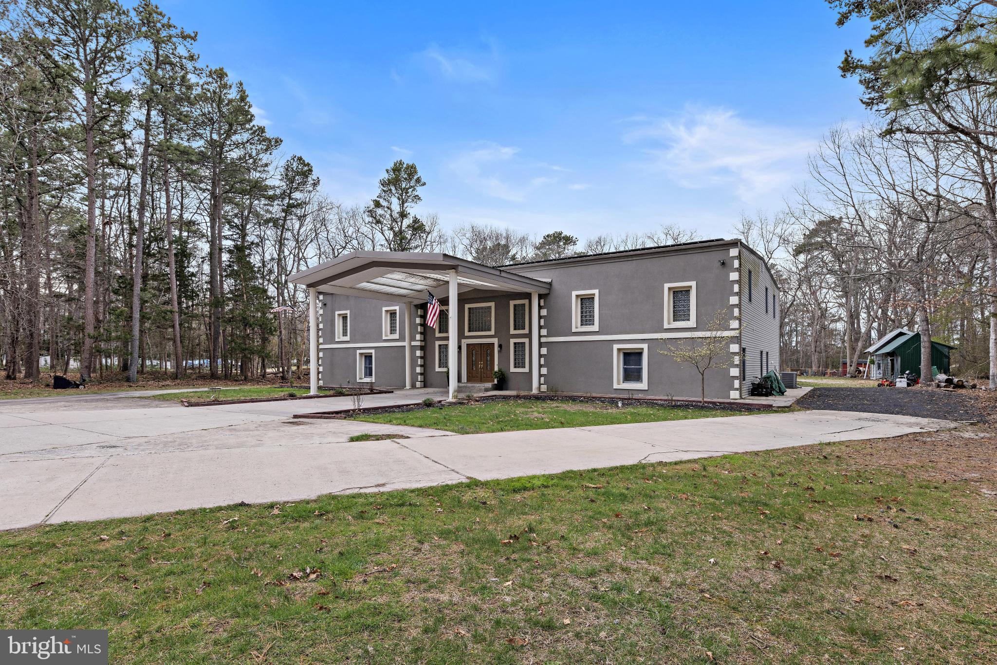 77 West Greenbush Road Tuckerton, NJ 08087 - Photo 72 of 75 a front view of a house with a yard and trees