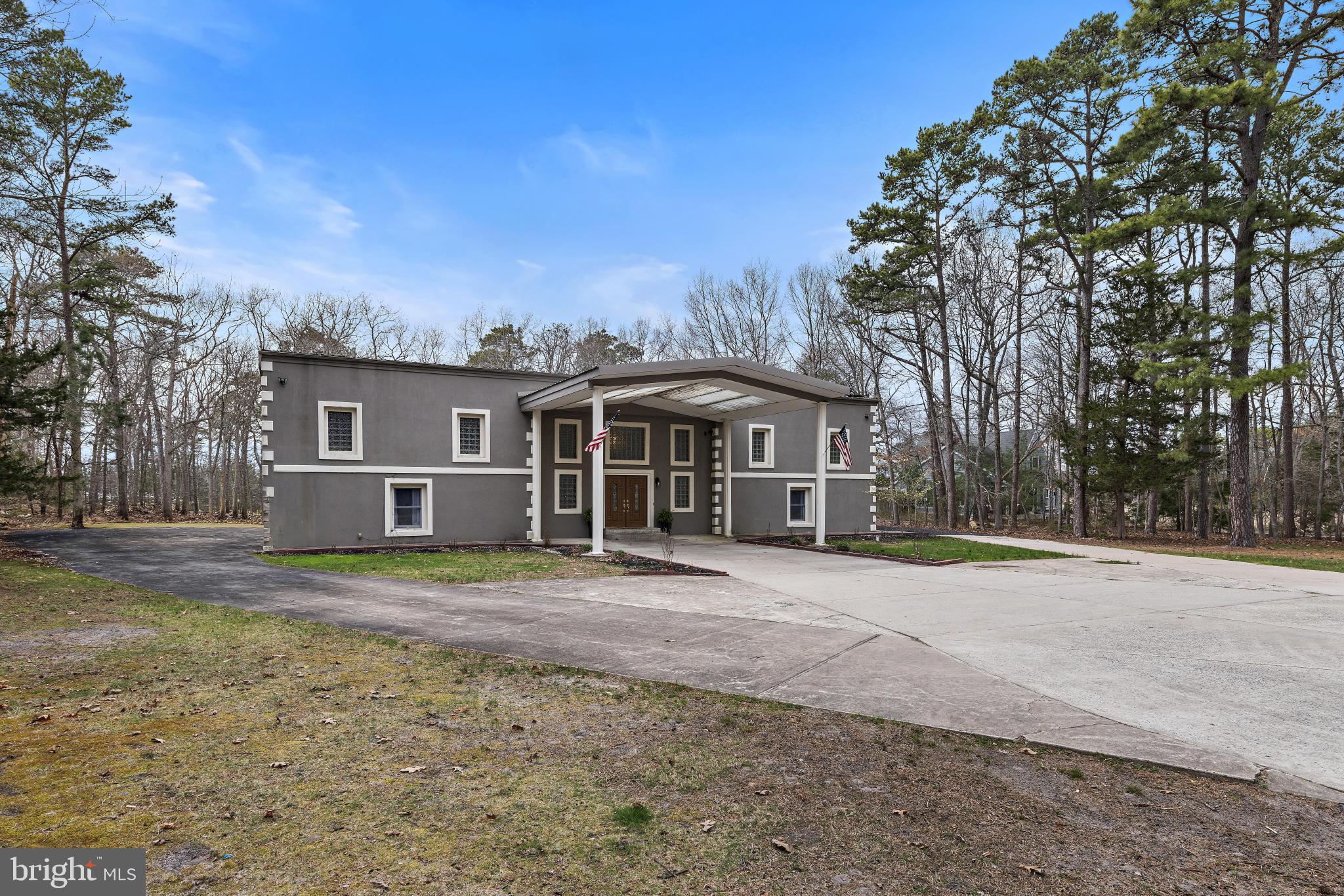 77 West Greenbush Road Tuckerton, NJ 08087 - Photo 73 of 75 a front view of a house with a dirt yard and a large tree