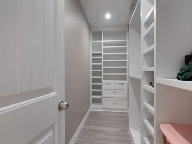 a view of walk in closet with empty racks