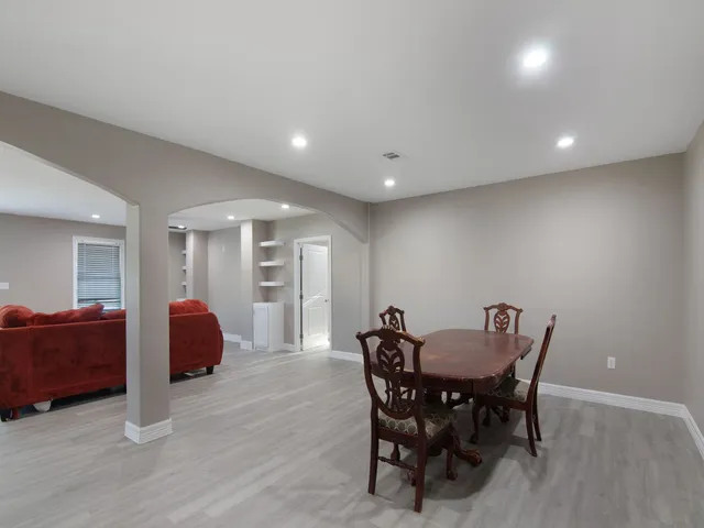 a view of a dining room with furniture and wooden floor
