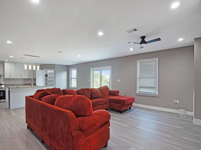 a living room with furniture window and wooden floor