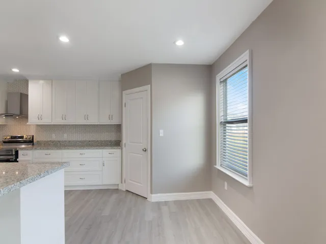 a view of kitchen with wooden floor and electronic appliances