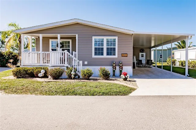 a front view of a house with a yard and potted plants