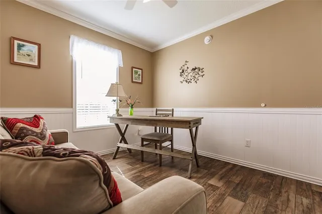 a view of a workspace with furniture and a window