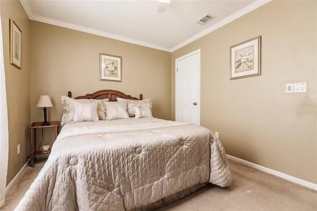 a bedroom with a bed and painting on the wall