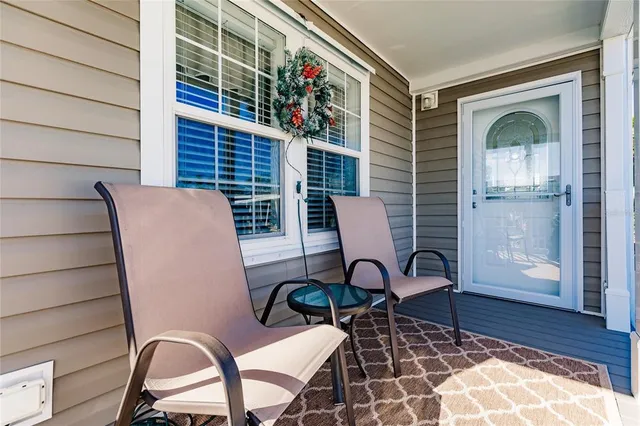 a view of a chairs and a table in the balcony