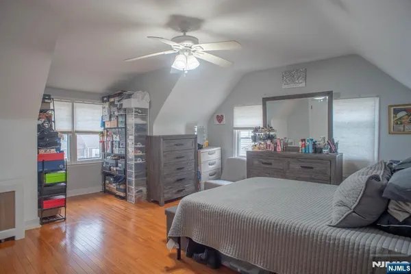 a bedroom with a bed and a mirror