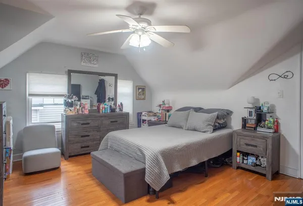 a bedroom with a bed chandelier and a couch