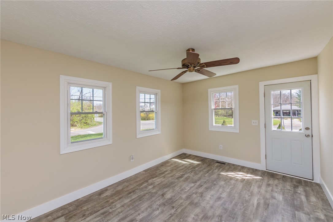 4510 Nettleton Road Medina, OH 44256 - Photo 6 of 27 The living room features lvt flooring and ceiling fan.The home has been painted with neutral colors